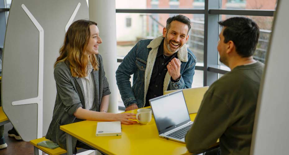 People laughing in a small meeting